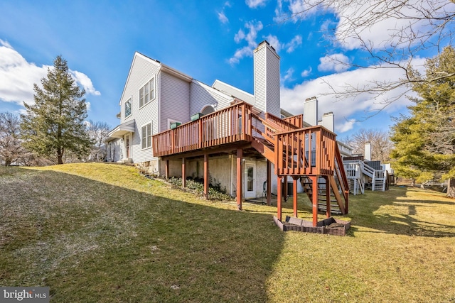 back of house featuring a lawn and a deck