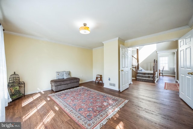 sitting room with dark wood-type flooring and ornamental molding