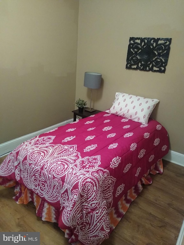 bedroom with hardwood / wood-style flooring