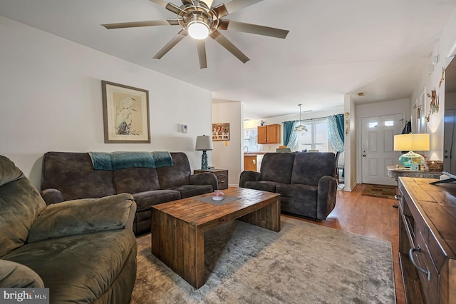 living room with dark hardwood / wood-style floors and ceiling fan