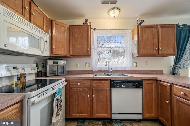 kitchen featuring sink and white appliances