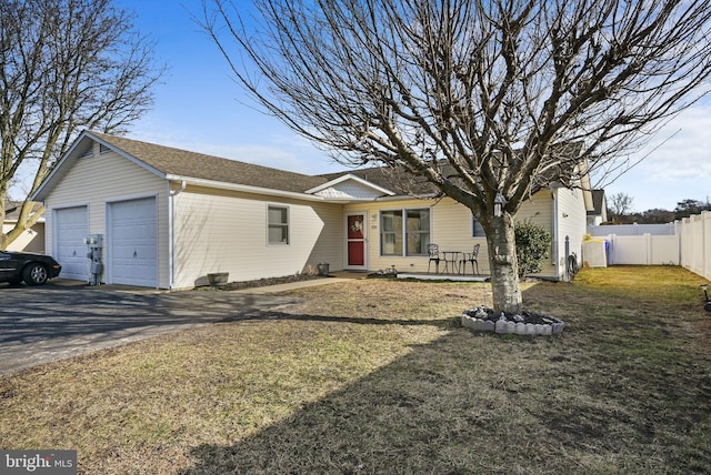 ranch-style house featuring a garage and a front yard