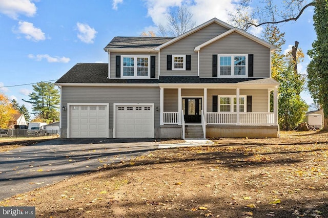 view of property featuring a porch and a garage