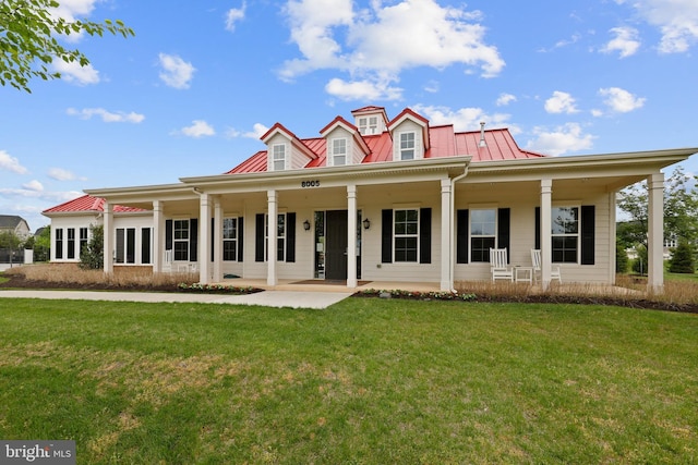 view of front of home with metal roof, a front lawn, and a porch