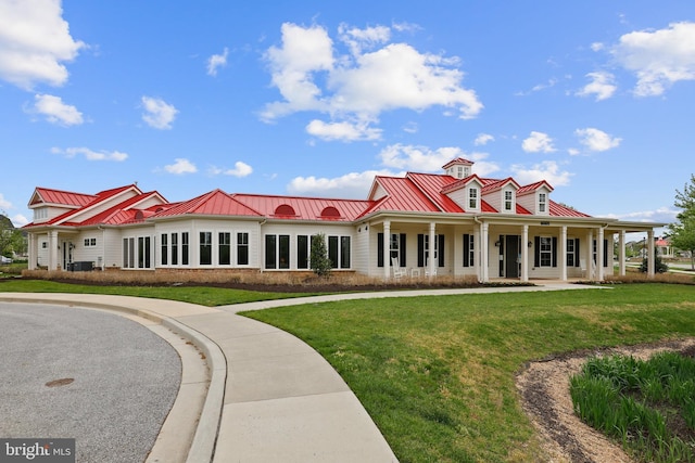 exterior space featuring metal roof, a standing seam roof, and a front yard