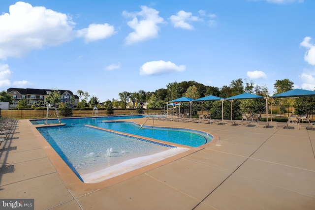 pool featuring fence and a patio