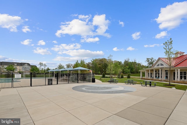 surrounding community with fence, a lawn, and a patio