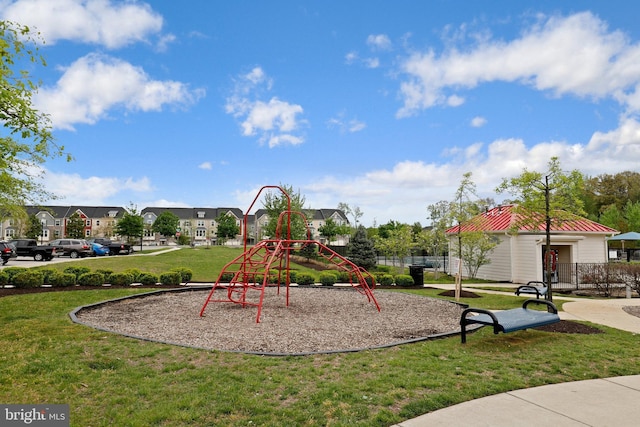 communal playground with a residential view and a lawn