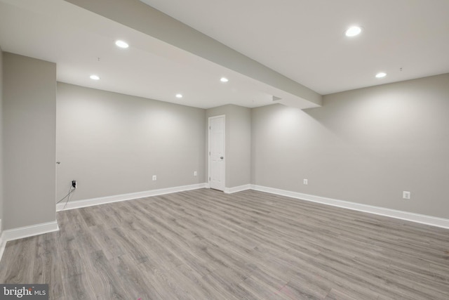 finished below grade area featuring recessed lighting, baseboards, and light wood finished floors