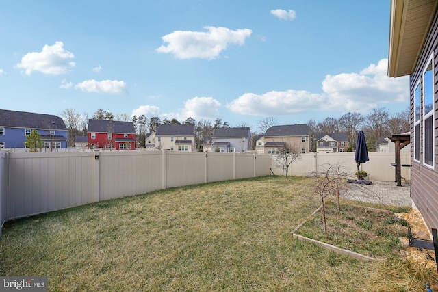 view of yard featuring a residential view and a fenced backyard