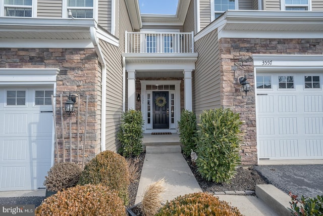 entrance to property with a garage and a balcony