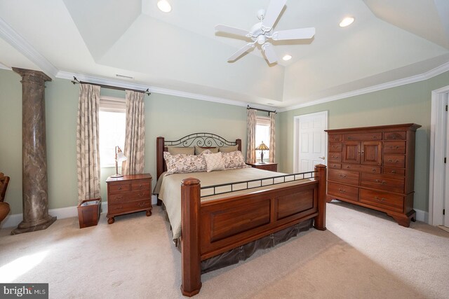 bedroom with light carpet, a raised ceiling, and decorative columns