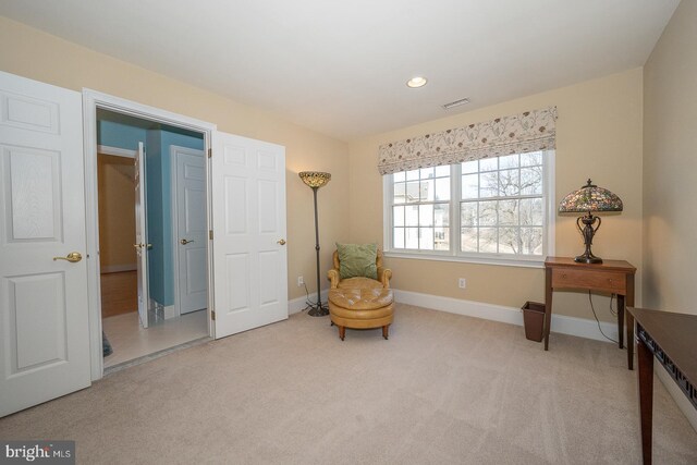 living area featuring light colored carpet, visible vents, baseboards, and recessed lighting