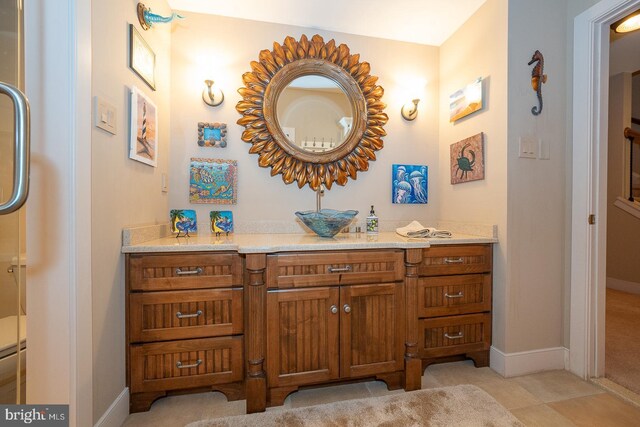 bathroom with baseboards and vanity