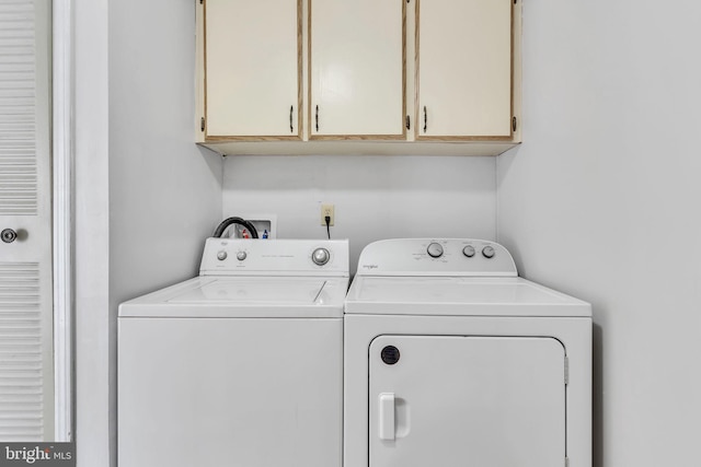 laundry area featuring cabinets and washing machine and dryer