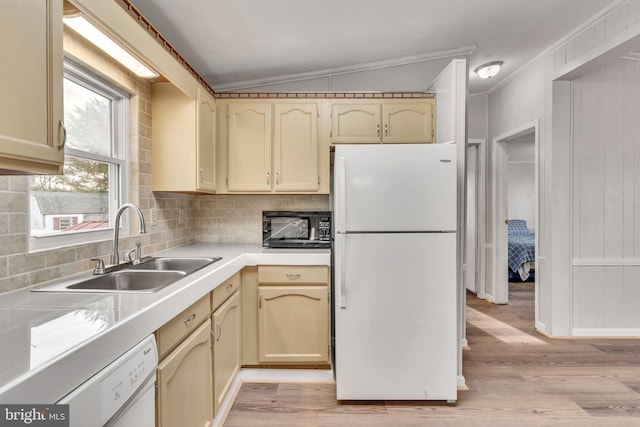 kitchen with sink, crown molding, white appliances, vaulted ceiling, and light wood-type flooring