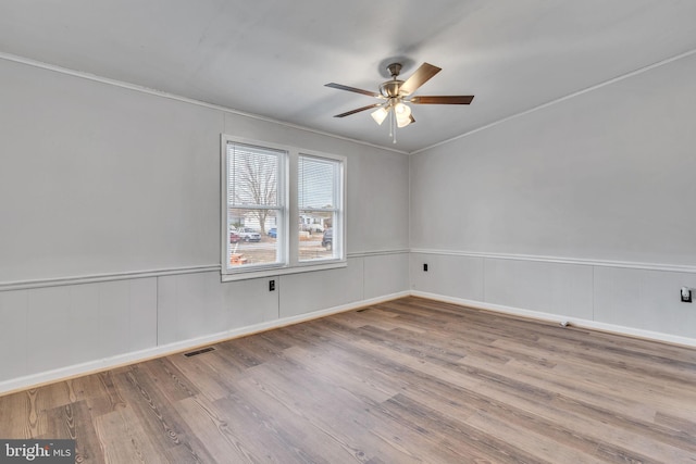 unfurnished room featuring ceiling fan and light hardwood / wood-style floors