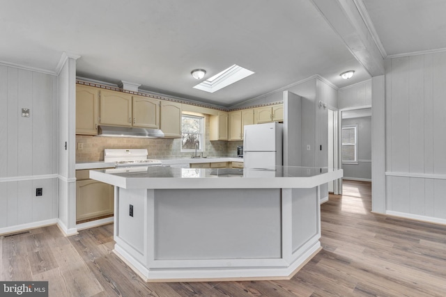 kitchen featuring a kitchen island, backsplash, light hardwood / wood-style floors, crown molding, and white appliances