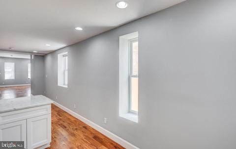 interior space with light wood-type flooring and white cabinets