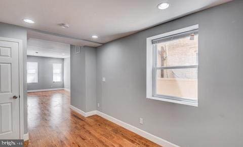 empty room with hardwood / wood-style flooring