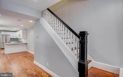 stairway featuring wood-type flooring