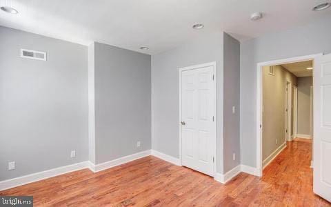 spare room with light hardwood / wood-style flooring