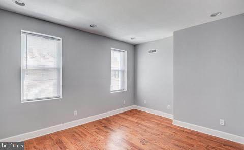 unfurnished room featuring hardwood / wood-style flooring