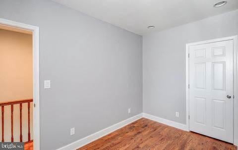 unfurnished room featuring hardwood / wood-style flooring