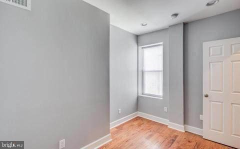 unfurnished bedroom with light wood-type flooring