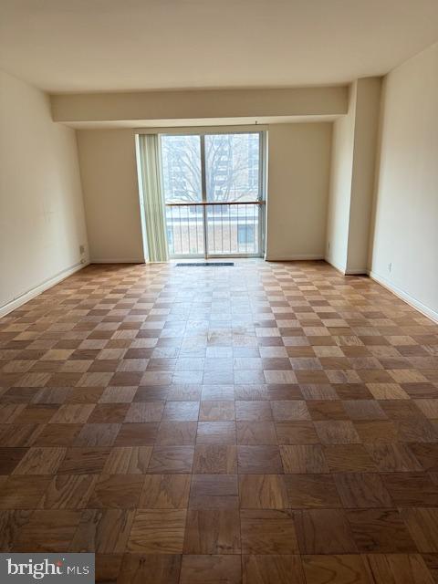 empty room featuring parquet flooring