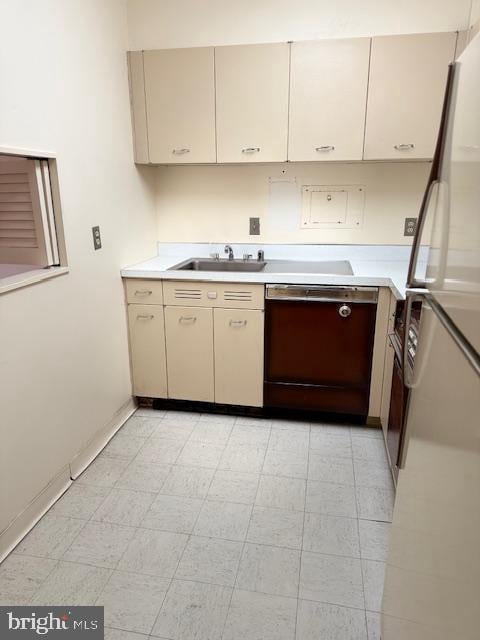 kitchen with cream cabinets, sink, dishwasher, and refrigerator