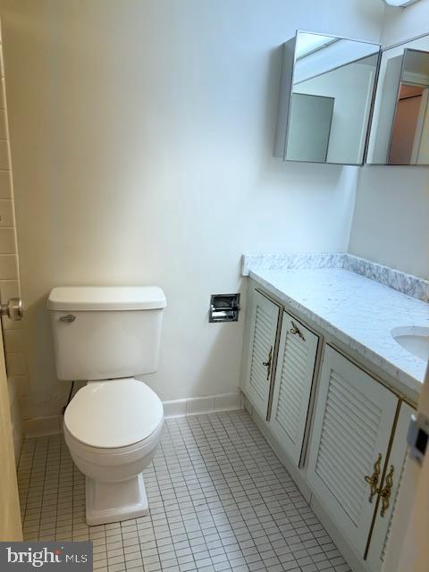 bathroom with vanity, tile patterned floors, and toilet