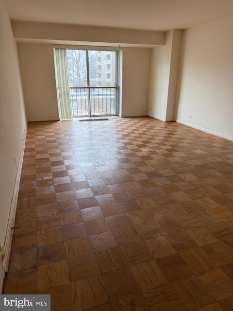 empty room with parquet flooring