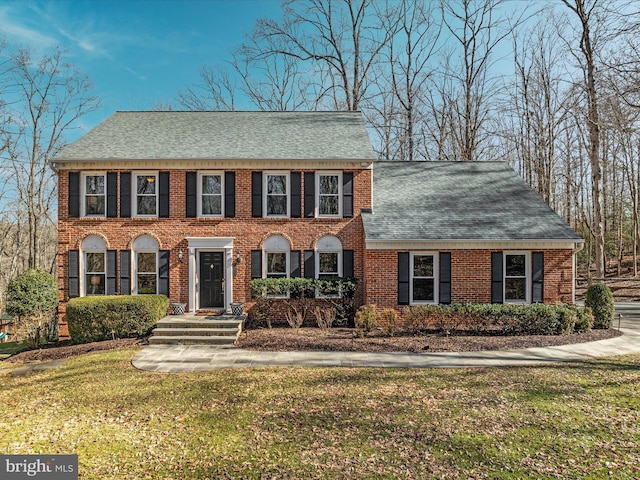 colonial-style house with a front yard