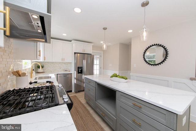 kitchen featuring hanging light fixtures, gray cabinets, white cabinets, and appliances with stainless steel finishes