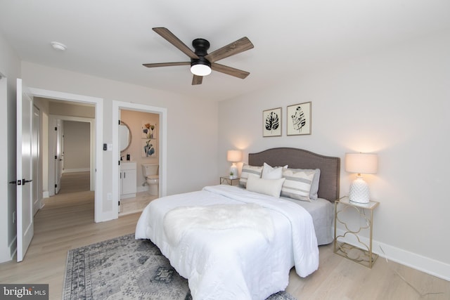 bedroom with connected bathroom, light hardwood / wood-style floors, and ceiling fan