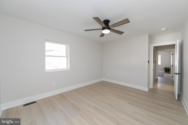 spare room with ceiling fan and light wood-type flooring