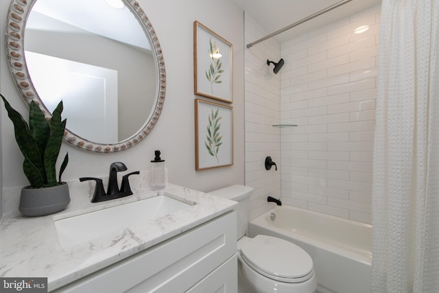 full bathroom featuring shower / bath combo, vanity, and toilet