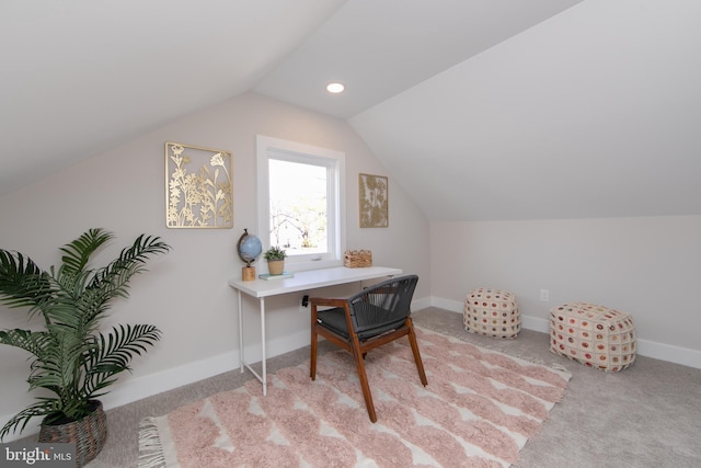 office area with vaulted ceiling and light colored carpet