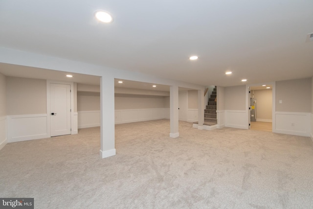 basement featuring light carpet