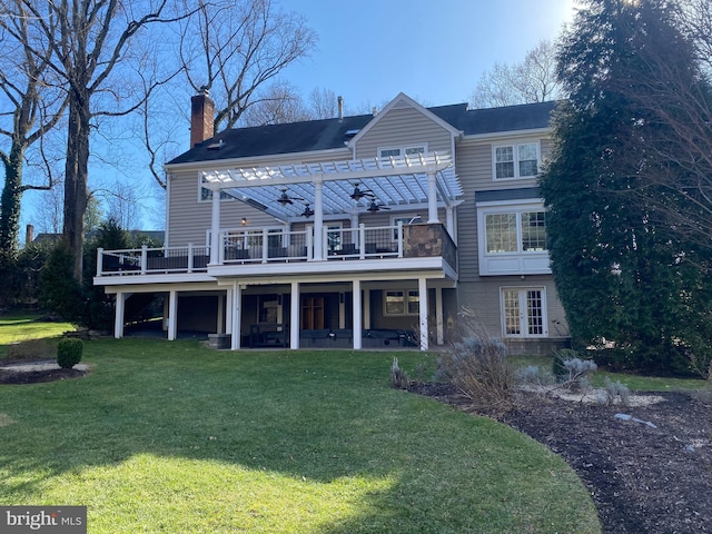 view of front of property with a pergola, a front yard, ceiling fan, and a deck