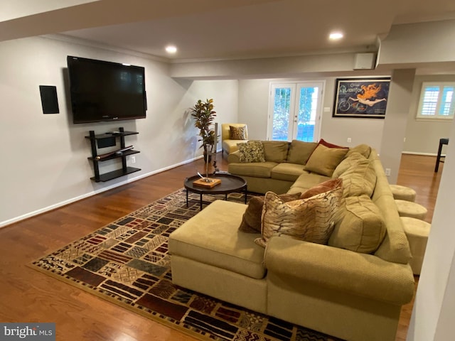 living room featuring hardwood / wood-style flooring, crown molding, and french doors