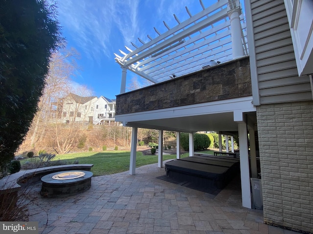 view of patio with a fire pit and a covered hot tub