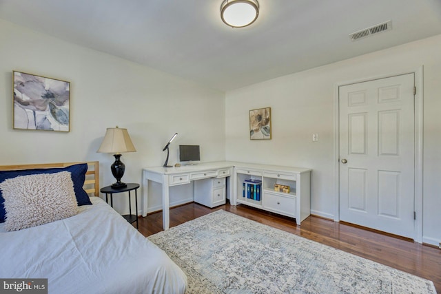 bedroom featuring dark hardwood / wood-style flooring