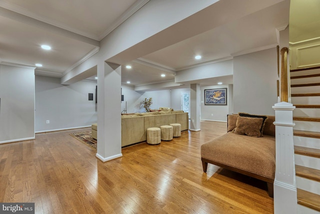 living room with crown molding and light wood-type flooring