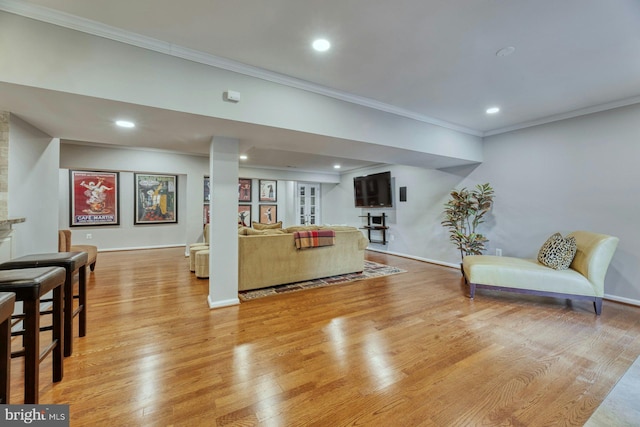 living room featuring ornamental molding and light wood-type flooring