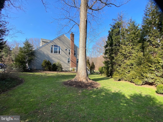 view of side of home with a lawn