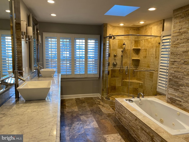 bathroom with vanity, plus walk in shower, and a skylight