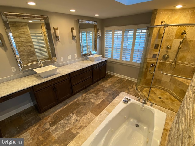 bathroom featuring vanity and separate shower and tub