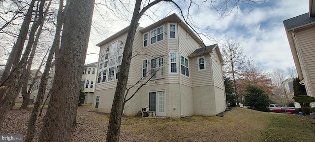 view of side of home with a yard